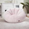Load image into Gallery viewer, Soft pink donut-shaped bean bag chair with plush texture in a cozy modern living room setting