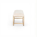 Load image into Gallery viewer, Ivory upholstered bench with brass-finished steel frame and bullnose edging on a white background