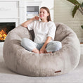 Load image into Gallery viewer, Cozy Beatrice Sofa Chair in plush almond faux fur with high-density foam, featuring a young woman sitting cross-legged indoors