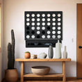 Load image into Gallery viewer, Life size black wall mounted Four in a Row game above wooden console table with decorative vases and cactus plant