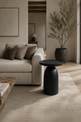Load image into Gallery viewer, HARLOW BLACK ACCENT TABLE beside sofa in living room and across from window and diagonal to a coffee table