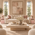 Load image into Gallery viewer, A beautifully styled living room featuring a cream-colored sofa with blush pink and beige pillows, a low wooden coffee table, pink stone tables, and a large abstract art print on the wall.