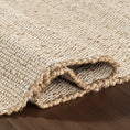 Load image into Gallery viewer, area rug close-up of it folded on hardwood floor