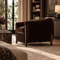Load image into Gallery viewer, A dark brown velvet barrel chair with dark wood legs, styled in a warm, sunlit living room next to a marble side table and a bookshelf.