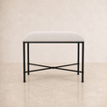 Load image into Gallery viewer, A modern bedroom bench with a light beige upholstered cushion and a black metal frame with an X-shaped base, set against a neutral beige background.