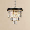Load image into Gallery viewer, A modern tiered crystal chandelier with a matte black metal frame and hanging chain, shown against a warm beige background.