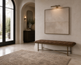 Load image into Gallery viewer, A large square framed wall art piece with a textured beige linen-like surface hangs on a cream stucco wall in a modern entryway. Below it is a tufted brown bench with a brass metal frame.