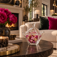 Load image into Gallery viewer, A clear glass candy bowl with a matching lid sits on a dark round coffee table in a luxurious living room. The bowl is filled with pink and gold wrapped chocolates.