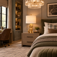 Load image into Gallery viewer, Cavadoodle lamp with a sculptural gold dog base and cream linen shade on a bedside table in a stylish boys' bedroom with green accents.