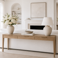 Load image into Gallery viewer, console table that is behind a sofa with flowers in a vase and a table lamp on it