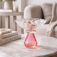 Load image into Gallery viewer, Pink crystal candy dish with wrapped candy on a marble coffee table
