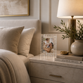 Load image into Gallery viewer, crystal picture frame with a textured, beaded border holding a family photo, styled on a marble nightstand next to a lit table lamp and a ceramic vase with greenery in a bedroom setting