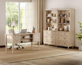 Load image into Gallery viewer, desk front view in front of a window with dressers with shelving and decor to the right of it