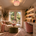 Load image into Gallery viewer, A beautifully styled home office or study featuring a pink velvet desk chair, a white desk with gold handles, built-in shelves with warm lighting, a pink floral chandelier, and a cozy cream sofa with pink throw pillows. The room is decorated with plants, framed art, and a large window looking out onto a garden.