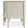 Load image into Gallery viewer, Side view of beige wooden executive desk with tapered legs and raised decorative paneling on the side