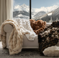 Load image into Gallery viewer, Faux Chinchilla Throw on sofa next to window with snow capped mountains outside of the window