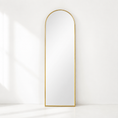 Load image into Gallery viewer, gold arched mirror in an all white room leaning against the wall