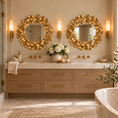 Load image into Gallery viewer, Two round gold mirrors with decorative leaf frames above a double-sink marble vanity in a luxurious master bathroom with brass fixtures.