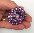 Load image into Gallery viewer, Close-up of amethyst jeweled rhinestone knob with purple crystals held between fingers on white background