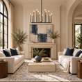 Load image into Gallery viewer, Lincoln black and gold 12-light chandelier above two cream sofas with blue accents