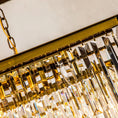 Load image into Gallery viewer, linear crystal chandelier close-up of a gold chandelier with crystal-like elements.