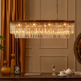 Load image into Gallery viewer, linear crystal chandelier in formal room with table underneath