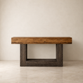 Load image into Gallery viewer, A rustic rectangular console table made from reclaimed wood, featuring a warm medium-brown top and dark weathered brown block legs, set against a neutral beige wall and floor.