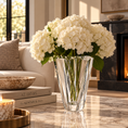 Load image into Gallery viewer, White hydrangea bouquet in the shannon crystal vase on a marble coffee table in a modern living room setting.