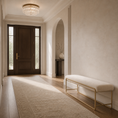 Load image into Gallery viewer, A modern entryway featuring a long beige area rug, a low upholstered bench with a gold metal frame, a dark wood double door, and a warm neutral textured wall.