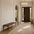Load image into Gallery viewer, A modern entryway featuring a dark brown wooden front door with glass panels, a woven brown wicker bench with black legs, a long beige runner rug, and a large beige ceramic vase with dried branches on the floor.