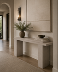 Load image into Gallery viewer, wooden console table in a warm neutral-toned entryway, styled with a ceramic vase of greenery and a stack of books beneath a large framed artwork.