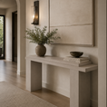Load image into Gallery viewer, wooden console table in a warm neutral-toned entryway, styled with a ceramic vase of greenery and a stack of books beneath a large framed artwork.