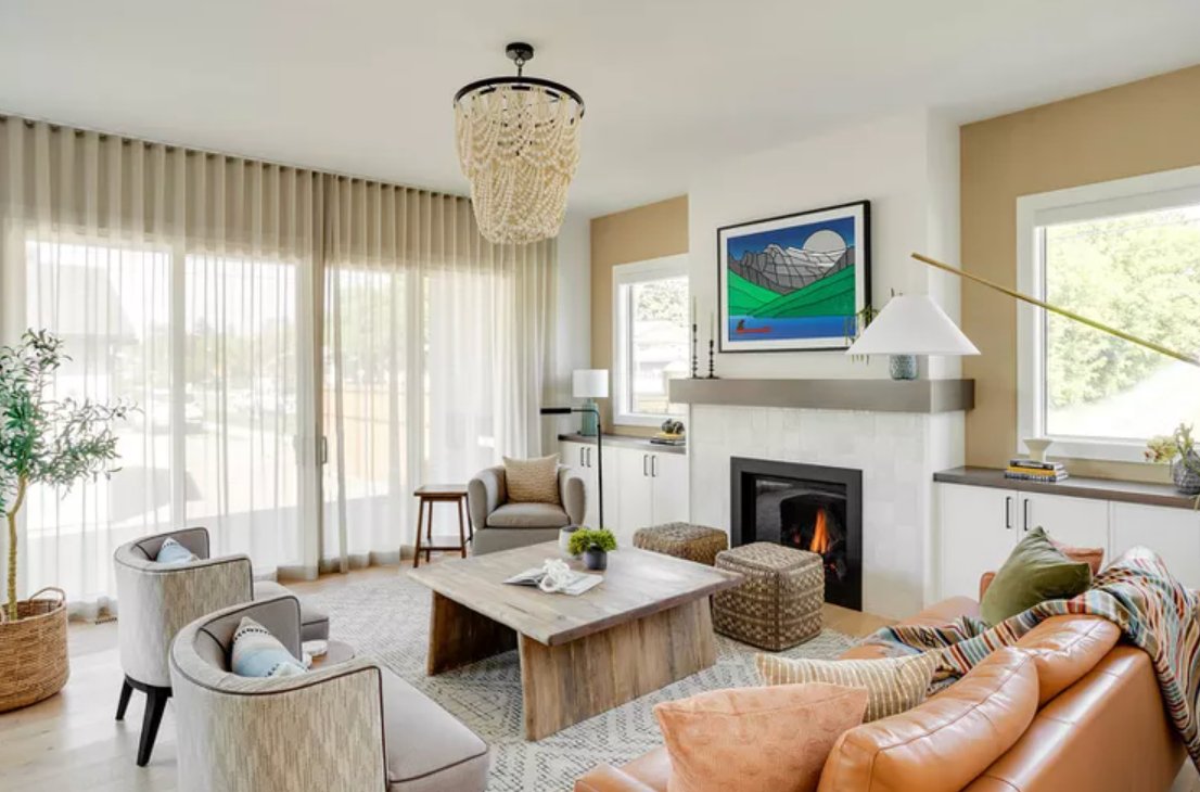 chandelier with a couch and fireplace in a room