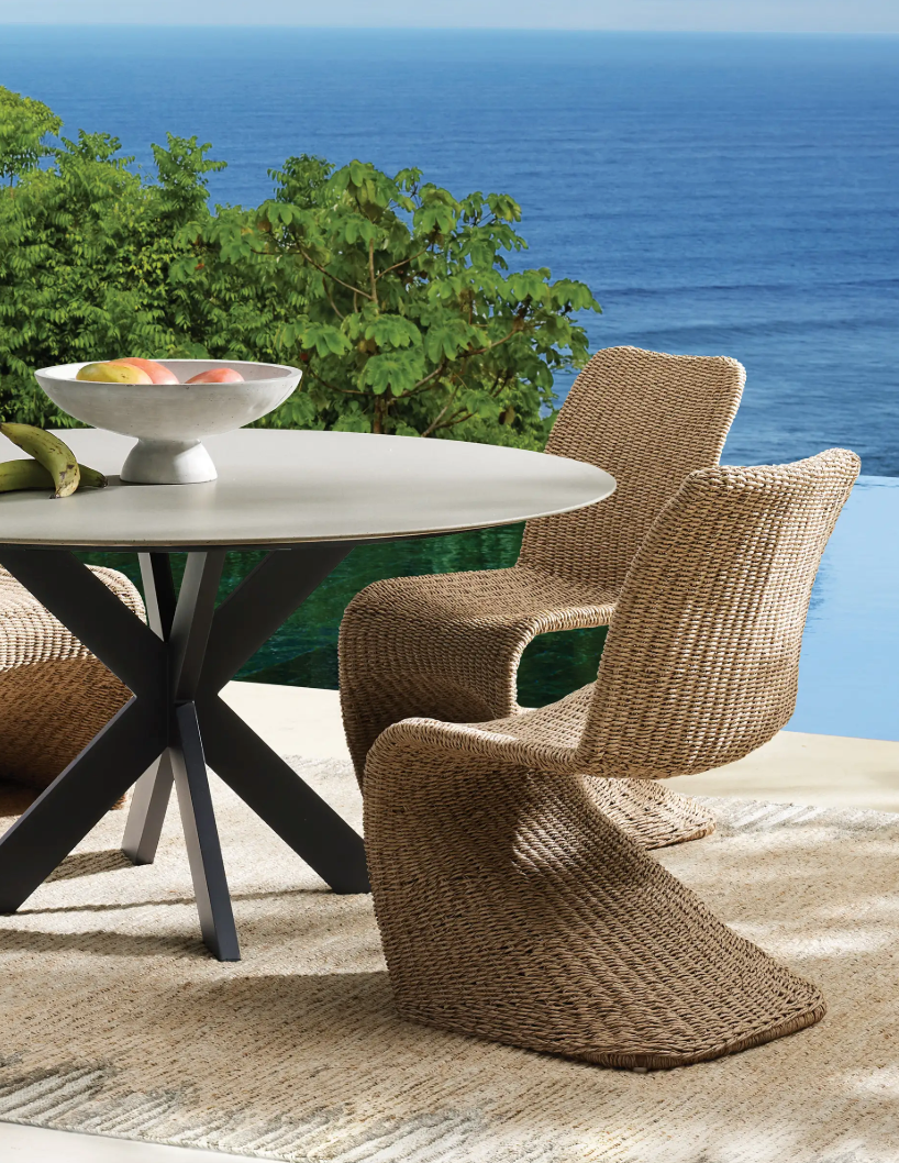 outdoor table and chairs near to the ocean