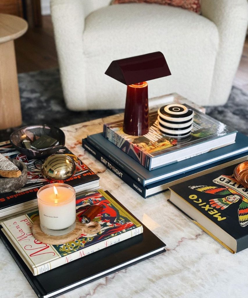 books and small lamp with candle