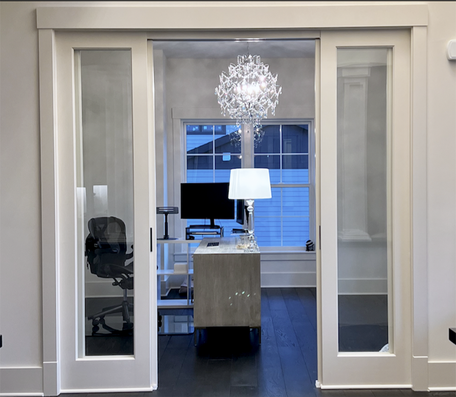 crystal chandelier hanging above desk in at-home office
