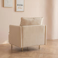 Load image into Gallery viewer, A beige House of Effy MINIMALIST ACCENT CHAIR with a cushioned backrest, positioned on a wooden floor beside a light pink wall adorned with framed art prints, embodies modern design and sturdy solid hardwood construction.
