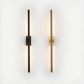 Load image into Gallery viewer, Two vertically mounted, minimalist wall lights with sleek, elongated designs are the perfect elegant addition to any space. The left light has a dark finish, and the right light has a gold finish. Both emit a soft, ambient glow, embodying House of Effy's MODERN LINEAR SCONCE elements with contemporary design flair.
