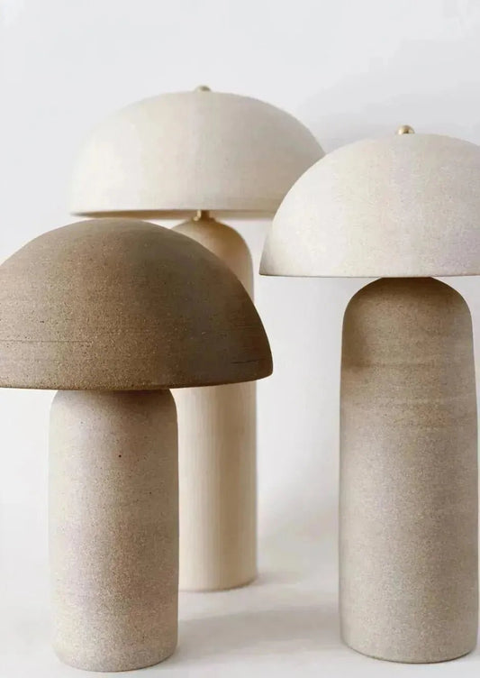 Three modern CERAMIC TABLE LAMPs by House of Effy with mushroom-like shapes in neutral colors stand against a white background, each crafted from high-quality ceramic material.