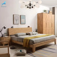 Load image into Gallery viewer, A minimalist bedroom with a wooden QUEEN MINIMALIST BED by House of Effy, gray and white bedding, a yellow throw, a bedside table, a wooden wardrobe, wall art, a modern light fixture, and a plant on top of the wardrobe exudes understated bedroom luxury.
