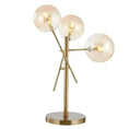 Load image into Gallery viewer, The House of Effy's GLASS BALL TABLE LAMP features a modern gold design with three asymmetrically arranged glass ball light bulbs on a circular base, creating an opulent glow and luxurious ambiance.
