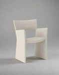 Load image into Gallery viewer, A luxurious, white CONTEMPORARY FABRIC DINING CHAIR by House of Effy with a curved backrest and wide armrests, embodying modern design and set against a plain gray background.
