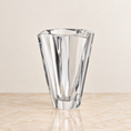 Load image into Gallery viewer, A clear faceted glass vase with a geometric, multi-sided design, standing on a light beige marble surface against a neutral cream background.
