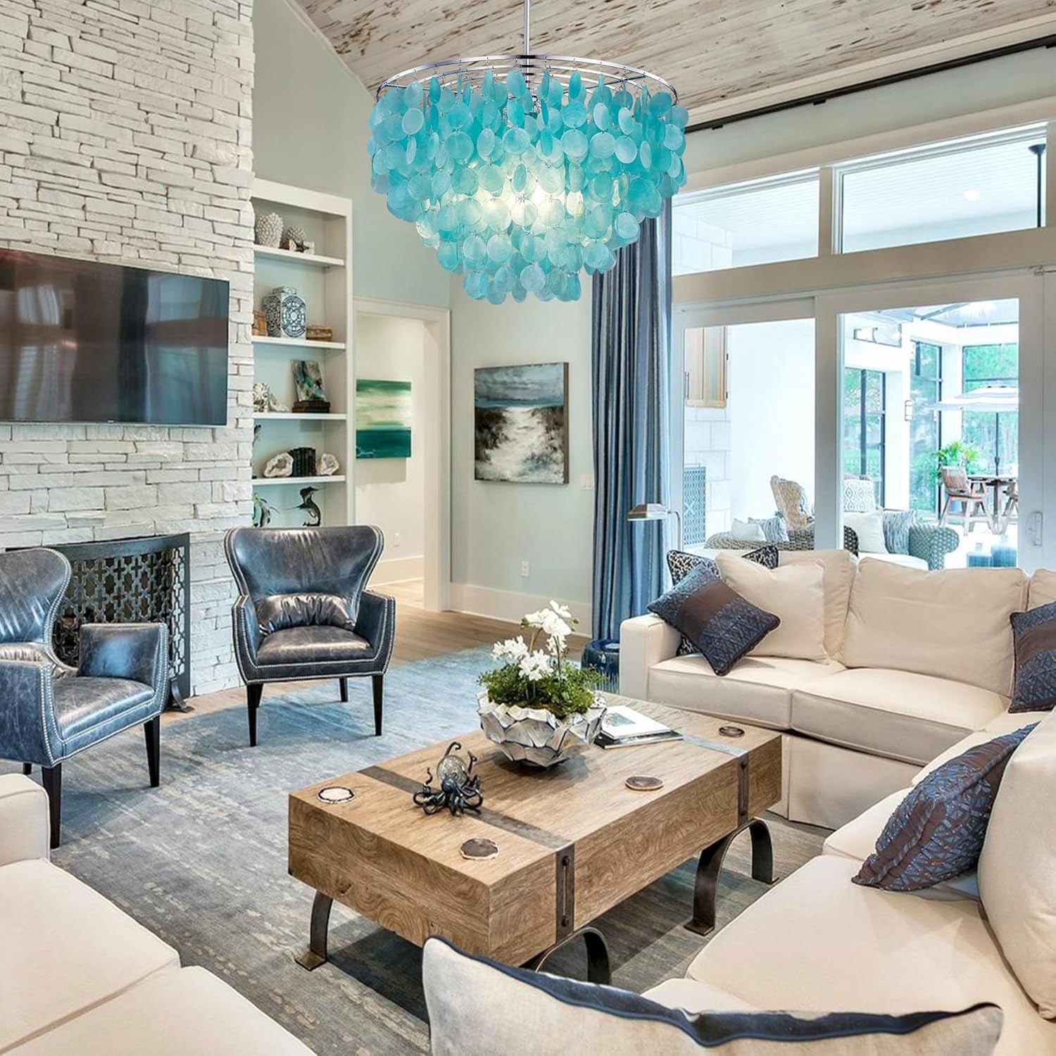 Capiz Shell Chandelier is over a coffee table in a living room that also has a sofa and chairs in it