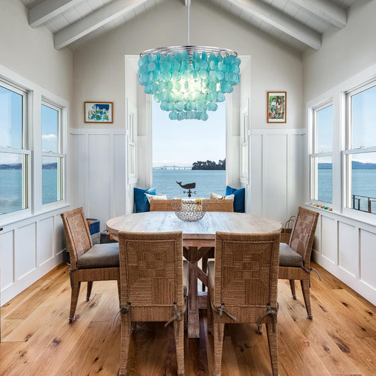 Capiz Shell Chandelier over a dining room table in a dining room with chairs and a table below it