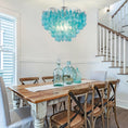 Load image into Gallery viewer, Capiz Shell Chandelier is in a dining room over a dining room table
