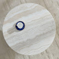 Load image into Gallery viewer, Cora Coffee Table is sitting on a rug and this view is looking down on it and it has  tea cup sitting on top of it
