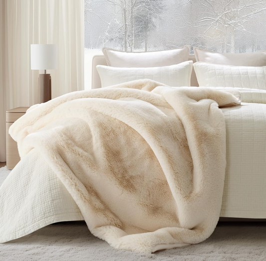 Faux Chinchilla Throw White on a bed in a bedroom