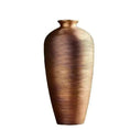 Load image into Gallery viewer, A tall, ribbed bronze modern ceramic vase with a narrow top, displayed against a neutral gray background by House of Effy.
