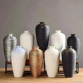 Load image into Gallery viewer, A collection of eleven BRONZE MODERN CERAMIC VASEs from House of Effy in various shapes and colors arranged on a wooden surface against a gray background.
